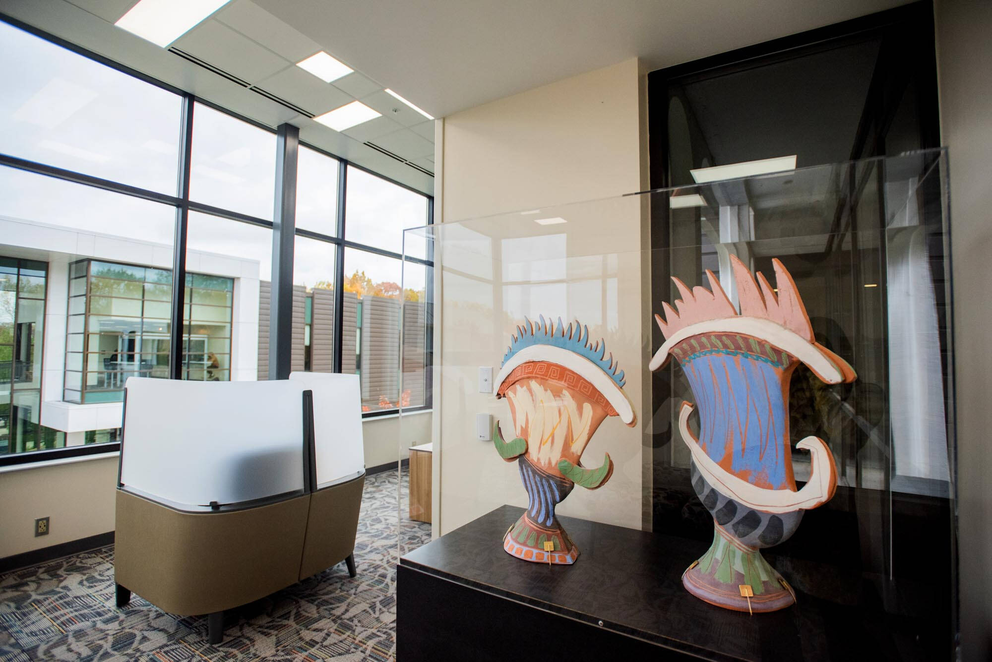 Interior room at Lake Huron Hall with two Greek-inspired ceramic sculptures.
